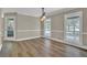 Bright dining room featuring wood floors, classic wainscoting, and modern lighting fixture at 2000 Mcconnell Rd, Grayson, GA 30017