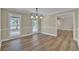 Open dining room boasting wood floors, classic wainscoting, and views to additional living spaces at 2000 Mcconnell Rd, Grayson, GA 30017