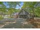 Attached two-car garage with a driveway, complemented by mature trees and a well-kept yard at 2000 Mcconnell Rd, Grayson, GA 30017
