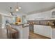 Open kitchen features granite countertops, stainless appliances, and breakfast bar with seating at 2000 Mcconnell Rd, Grayson, GA 30017