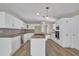 Updated kitchen with white cabinetry, granite countertops, stainless appliances, and sleek breakfast bar at 2000 Mcconnell Rd, Grayson, GA 30017