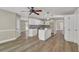 Bright eat-in kitchen featuring wood floors, white cabinets, and a functional breakfast bar at 2000 Mcconnell Rd, Grayson, GA 30017