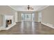 Bright and airy living room with hardwood floors, fireplace, and access to the outdoor patio at 2000 Mcconnell Rd, Grayson, GA 30017