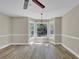 Well-lit living room features wood floors, large bay windows, and classic wainscoting details at 2000 Mcconnell Rd, Grayson, GA 30017