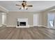 Spacious living room with hardwood floors, a fireplace, and ample natural light at 2000 Mcconnell Rd, Grayson, GA 30017