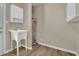 Bright utility room with hanging storage, cabinets, a sink and wood look flooring at 2000 Mcconnell Rd, Grayson, GA 30017