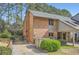 Brick exterior featuring a carport, well-maintained lawn, and mature landscaping at 2459 Cedar Canyon Se Ct, Marietta, GA 30067