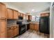 This kitchen features wood cabinets and black appliances at 2459 Cedar Canyon Se Ct, Marietta, GA 30067