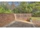 Private outdoor patio enclosed by a brick wall, with natural landscaping at 2459 Cedar Canyon Se Ct, Marietta, GA 30067