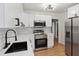 Well-lit kitchen featuring modern appliances, neutral cabinets, and white subway tile backsplash at 1291 Oakland Sw Ter, Atlanta, GA 30310