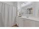 Clean and modern bathroom with white vanity, large mirror, and shower-tub combo at 1846 Liberty Ln, Roswell, GA 30075