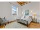 Serene bedroom featuring hardwood floors, a large window, and stylish furnishings at 1846 Liberty Ln, Roswell, GA 30075