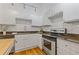 Bright kitchen with white cabinets, stainless steel appliances, and subway tile backsplash at 1846 Liberty Ln, Roswell, GA 30075