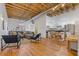 Open concept living space with exposed beam ceiling, hardwood floors and stainless steel appliances at 1846 Liberty Ln, Roswell, GA 30075