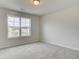 Bright bedroom features a large window and neutral carpet and paint at 4544 Eastbrook Pl, Snellville, GA 30039