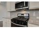 Kitchen highlights stainless appliances, granite counters, and modern design, creating a desirable culinary space at 4544 Eastbrook Pl, Snellville, GA 30039