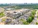 Aerial view of a neighborhood with townhomes, commercial buildings, and lush green trees at 6596 Aria Village Dr # 642, Atlanta, GA 30328