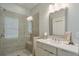 Modern bathroom featuring glass shower doors, neutral tile, and a spacious vanity at 6596 Aria Village Dr # 642, Atlanta, GA 30328