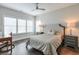 Bright bedroom with hardwood floors, desk, and patterned bedspread at 6596 Aria Village Dr # 642, Atlanta, GA 30328