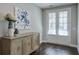 Inviting entryway with dark hardwood floors, stylish console table, and double doors with bright natural light at 6596 Aria Village Dr # 642, Atlanta, GA 30328