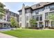 Well-manicured lawn and stylish exterior of a multi-story townhome with dark window trim at 6596 Aria Village Dr # 642, Atlanta, GA 30328