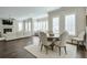 Spacious living room with fireplace, ample seating, and natural light, flowing into the dining area at 6596 Aria Village Dr # 642, Atlanta, GA 30328