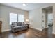 Cozy living area with a comfortable couch and natural light streaming through the window at 6596 Aria Village Dr # 642, Atlanta, GA 30328