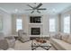 Inviting living room featuring a fireplace, ceiling fan, and comfortable seating at 6596 Aria Village Dr # 642, Atlanta, GA 30328