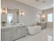 Bright bathroom with modern fixtures, double vanity, and a soaking tub at 6596 Aria Village Dr # 642, Atlanta, GA 30328