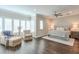 Bright main bedroom with hardwood floors, ceiling fan, sitting area, and patterned bedspread at 6596 Aria Village Dr # 642, Atlanta, GA 30328