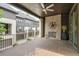 Covered patio with an outdoor fireplace, ceiling fan, and exterior views of the surrounding neighborhood at 6596 Aria Village Dr # 642, Atlanta, GA 30328