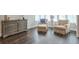 Relaxing sitting area with hardwood floors, two armchairs and dresser at 6596 Aria Village Dr # 642, Atlanta, GA 30328