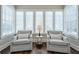 Bright sitting area with plush armchairs and a large window offering natural light and tranquil views at 6596 Aria Village Dr # 642, Atlanta, GA 30328
