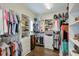 Spacious walk-in closet with shelves and multiple hanging rods at 6596 Aria Village Dr # 642, Atlanta, GA 30328