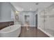 Spa-like bathroom showcasing a soaking tub, glass shower, and elegant finishes at 6739 Encore Blvd, Atlanta, GA 30328