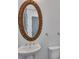 Elegant half bath with a pedestal sink, decorative mirror and classic fixtures at 6739 Encore Blvd, Atlanta, GA 30328