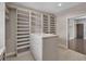Large walk-in closet with custom shelving and an island with drawers at 6739 Encore Blvd, Atlanta, GA 30328
