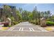 Neighborhood brick entrance with brick-lined street and lush landscaping on a bright sunny day at 6739 Encore Blvd, Atlanta, GA 30328