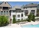 Close exterior shot of an upscale townhome, featuring manicured landscaping and pool access at 6739 Encore Blvd, Atlanta, GA 30328