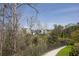 View of modern upscale neighborhood and lush landscaping on a sunny day with bright skies at 6739 Encore Blvd, Atlanta, GA 30328