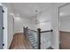Bright hallway with hardwood floors, decorative lighting, and staircase at 6739 Encore Blvd, Atlanta, GA 30328