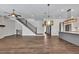 Spacious living room featuring hardwood floors, modern staircase, and stylish light fixtures at 6739 Encore Blvd, Atlanta, GA 30328