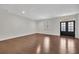 Spacious living room with hardwood floors, bright windows, and stylish glass pane doors at 6739 Encore Blvd, Atlanta, GA 30328