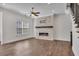 Bright living room featuring a stone fireplace and staircase at 6739 Encore Blvd, Atlanta, GA 30328