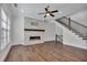 Comfortable living area with a stone fireplace, large windows, and elegant staircase at 6739 Encore Blvd, Atlanta, GA 30328