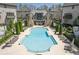 Poolside view of the community pool and luxurious townhomes and patio seating at 6739 Encore Blvd, Atlanta, GA 30328