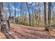 Backyard area with a deck overlooking a wooded lot filled with a canopy of trees at 9224 Snipe Ln, Jonesboro, GA 30236