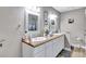 Bright bathroom with double sinks, a vanity, and ample counter space at 9224 Snipe Ln, Jonesboro, GA 30236