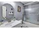 Bathroom featuring a white vanity, a wall mirror, and a shower-tub combination at 9224 Snipe Ln, Jonesboro, GA 30236