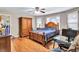 This home features a bedroom with hardwood floors, a ceiling fan, and lots of natural light from the windows at 9224 Snipe Ln, Jonesboro, GA 30236